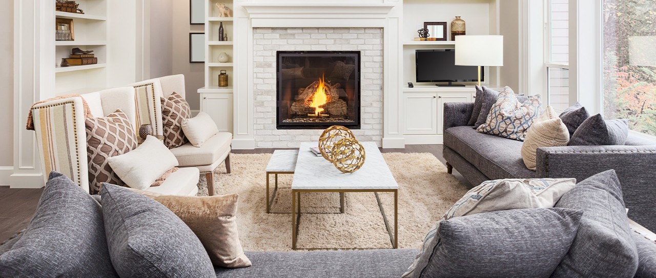 Large living room with sofas, chairs, coffee tables, and a fireplace.